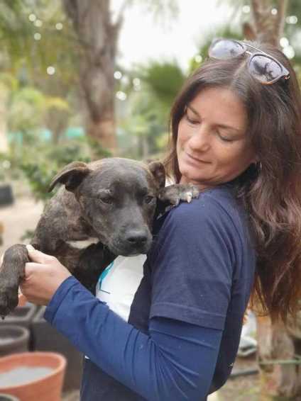 Richelle holding a rescued dog