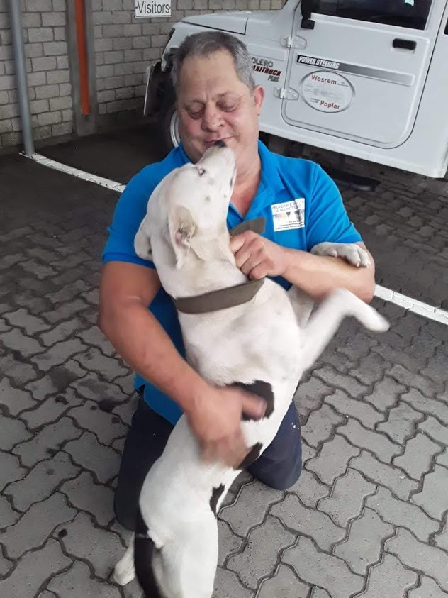 A dog licking a man's face.